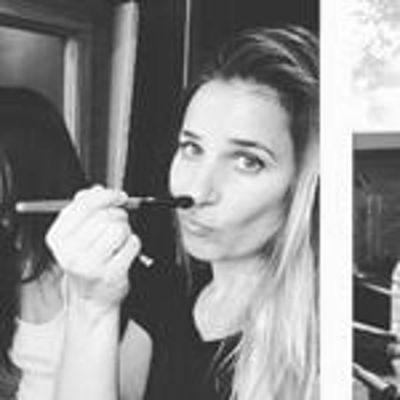 She is holding the makeup brush by her nose in this monochrome image.